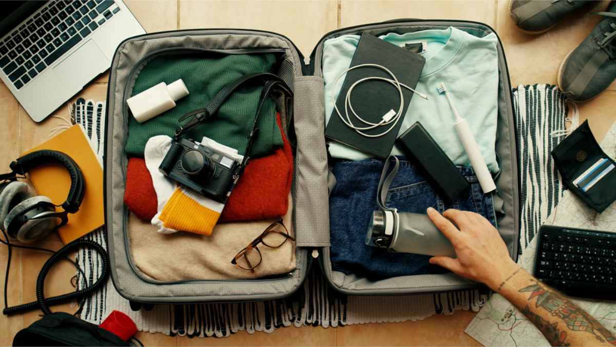 Suitcase wide open and filled with clothes and personal items