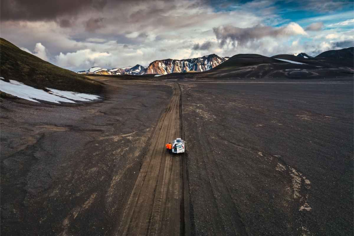 Best vehicles for an Iceland Highlands itinerary White rooftop tent 4x4 vehicle heading into Iceland´s highlands