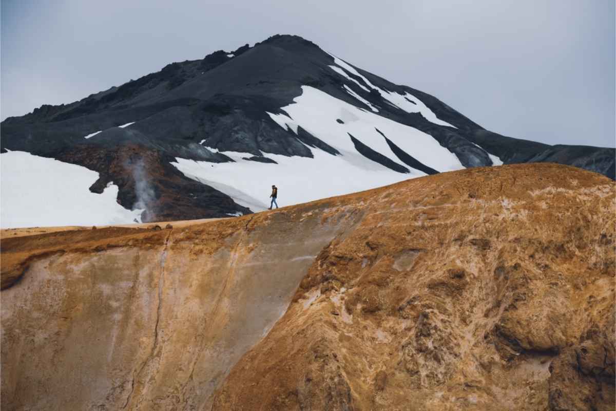 Highlands of Iceland itinerary Hiker walking down the mountains of Landmannalaugar