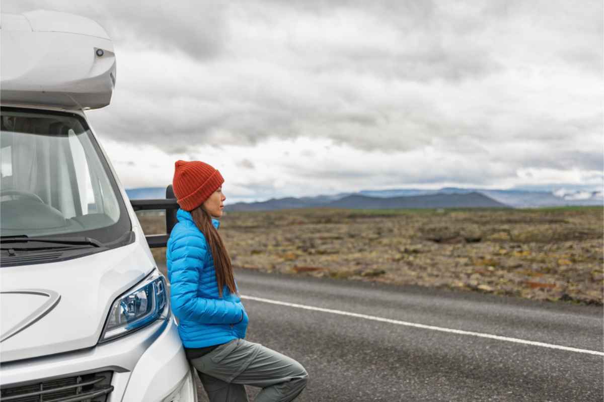 Woman leaning onto a large white motorhome