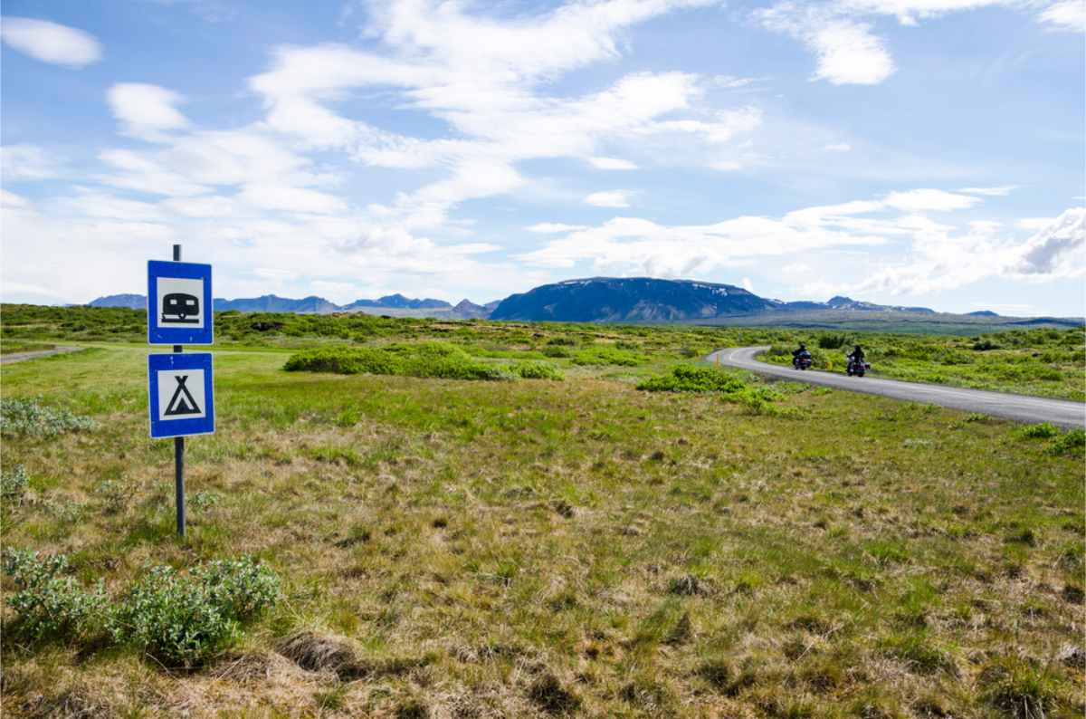 Designated campsites in Iceland Golden Circle Camping area with a blue camping sign in Iceland
