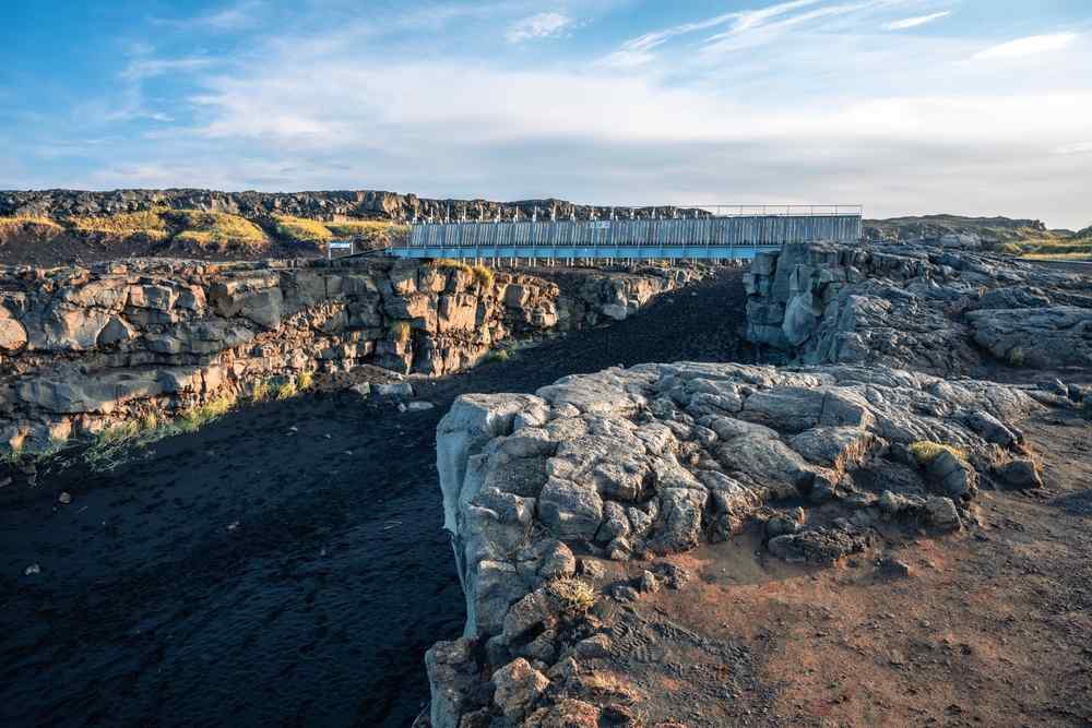 Bridge Between Continents crossing a rocky fissure on the Reykjanes Peninsula in Iceland.