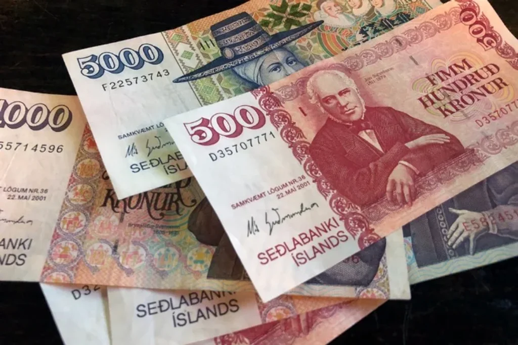 Icelandic banknotes of various denominations, featuring portraits of historical figures and colorful designs, representing the Icelandic króna