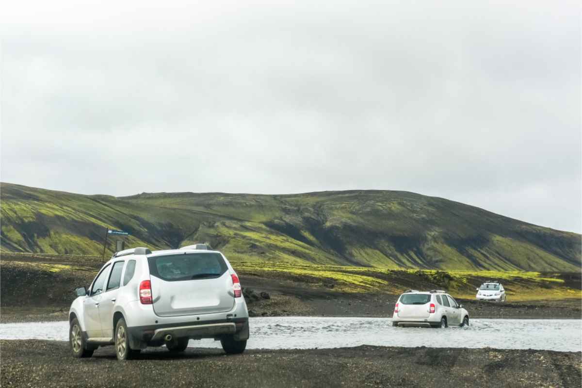 4x4 vehicles fording a river in Iceland's highlands