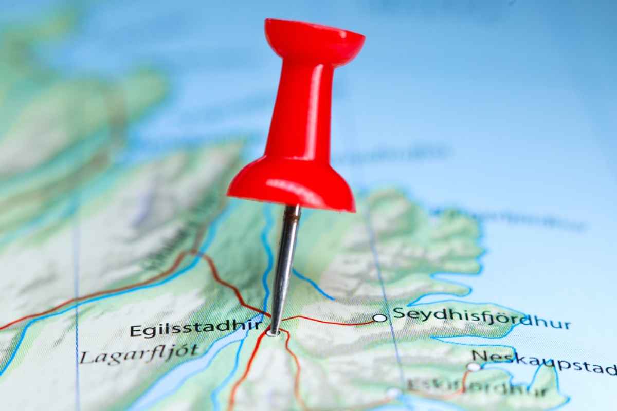 Tourist in her rental campervan in Iceland near a beautiful waterfall