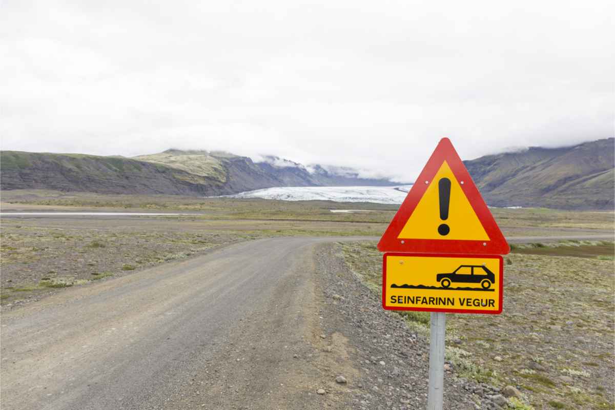 Gravel Road Insurance Road sign showing gravel roads and uneven road surface