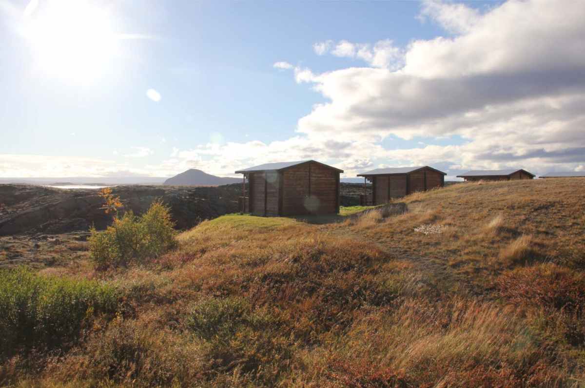 View of wood cabins located near Lake Myvatn on a sunny day