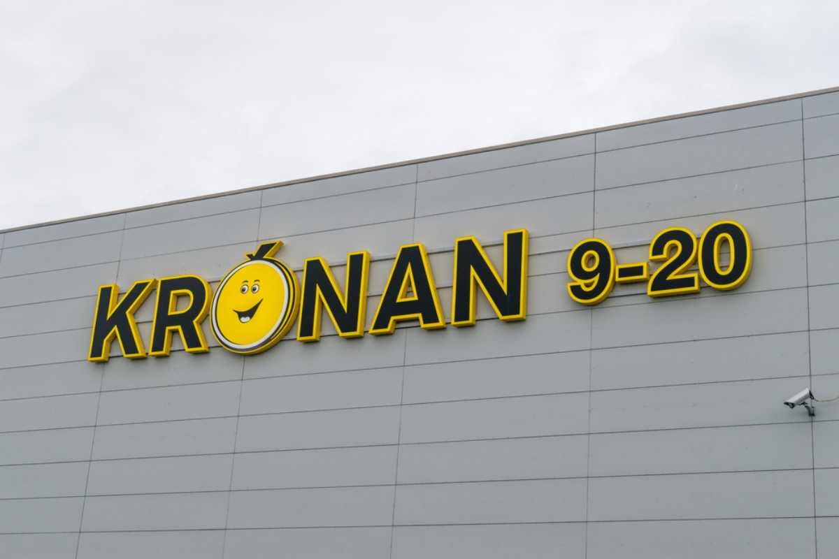 Dónde comprar comida en Islandia Primer plano de un cartel de supermercado Krónan sobre un edificio gris en Islandia